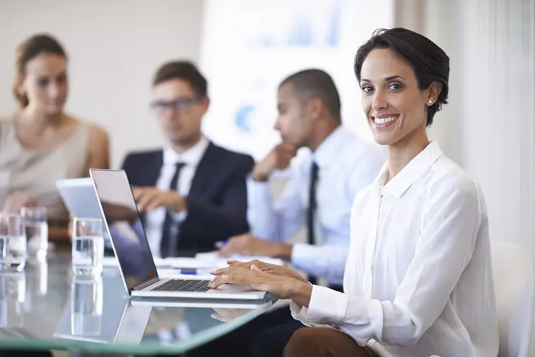 Smiling professional woman in office meeting.